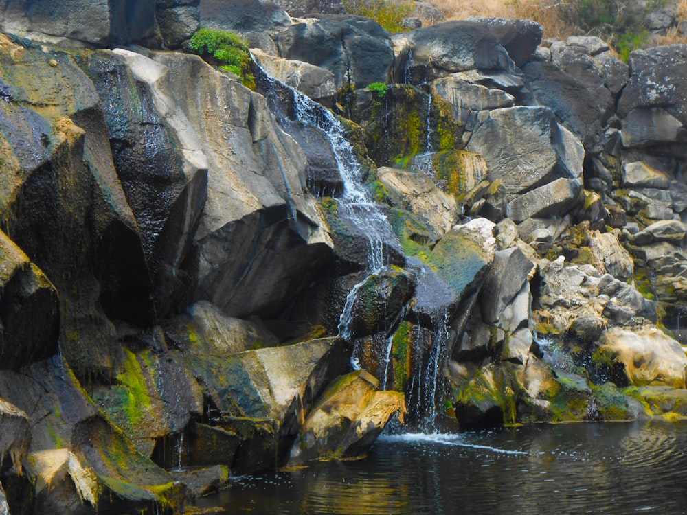 a rocky cliff with water