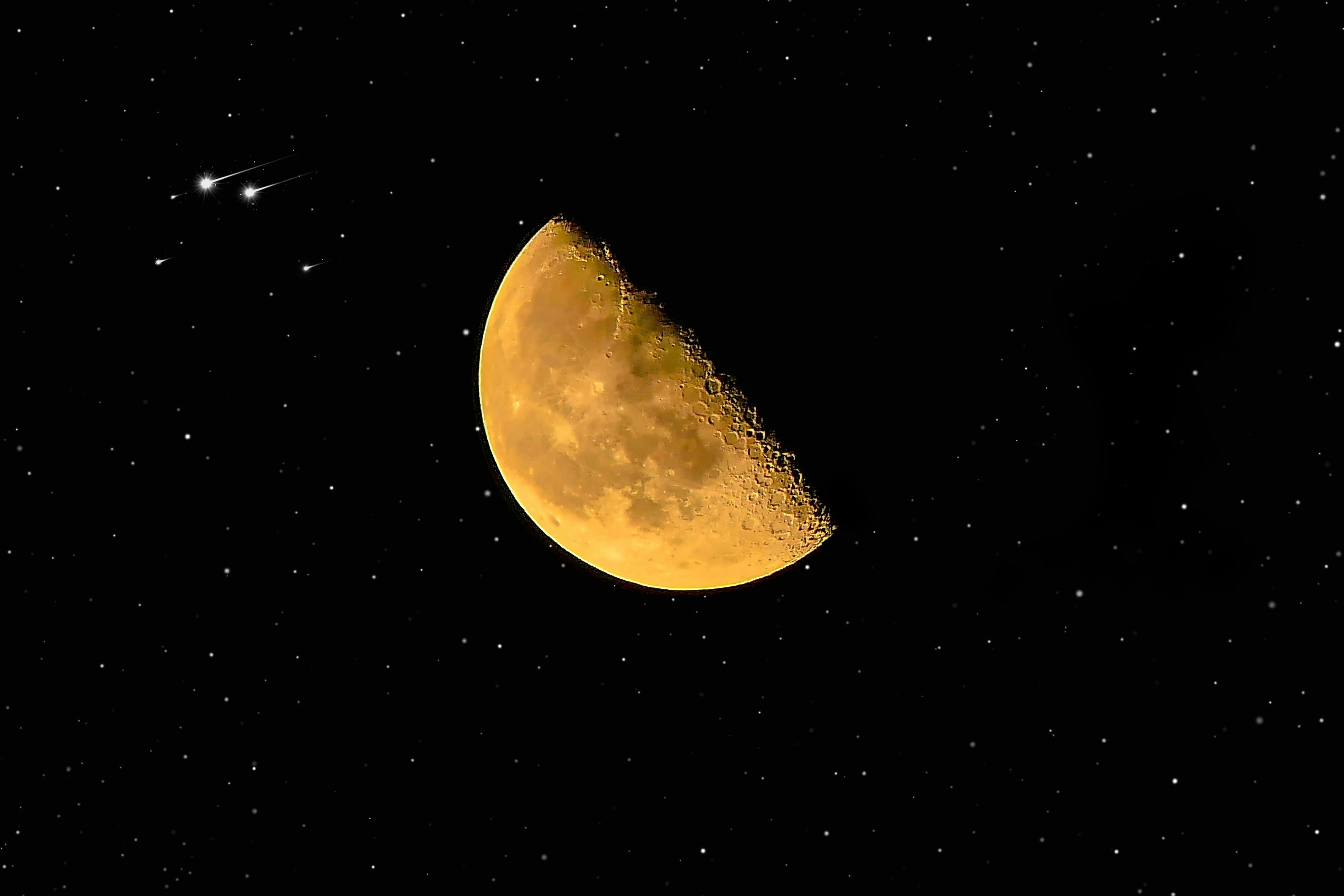 Golden crescent Moon glows against a star-filled night sky, with a bright meteor streaking near the top-left.