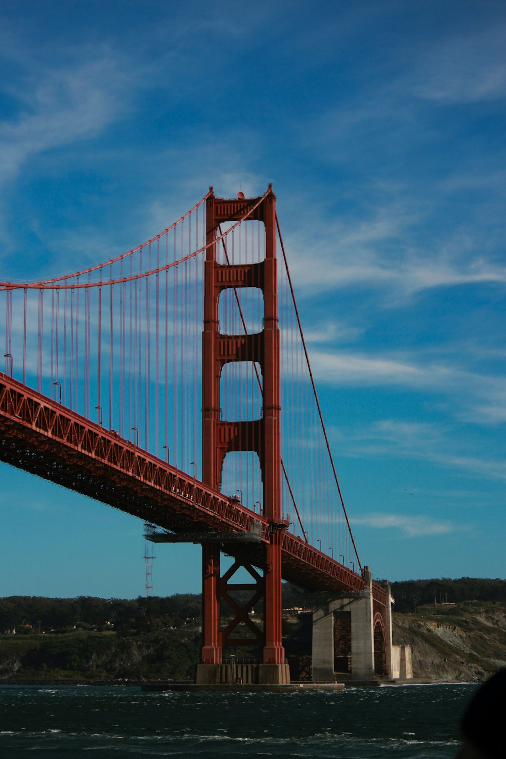 a large red bridge with Golden Gate Bridge in the background