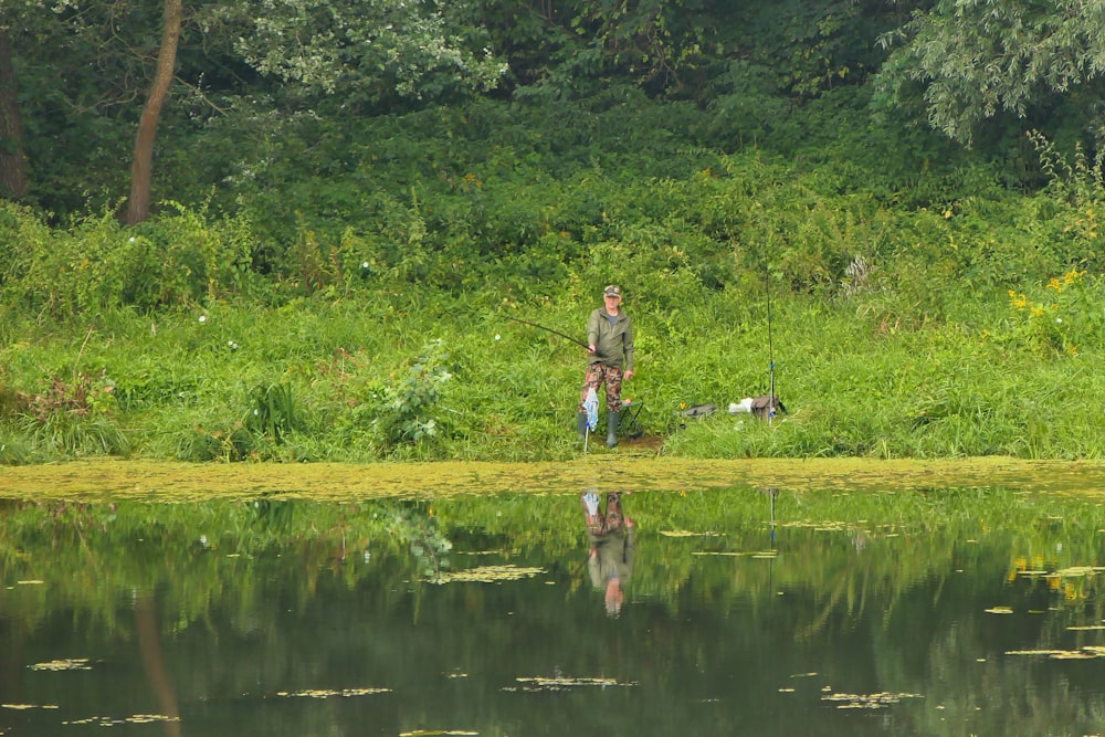 a person fishing in a pond
