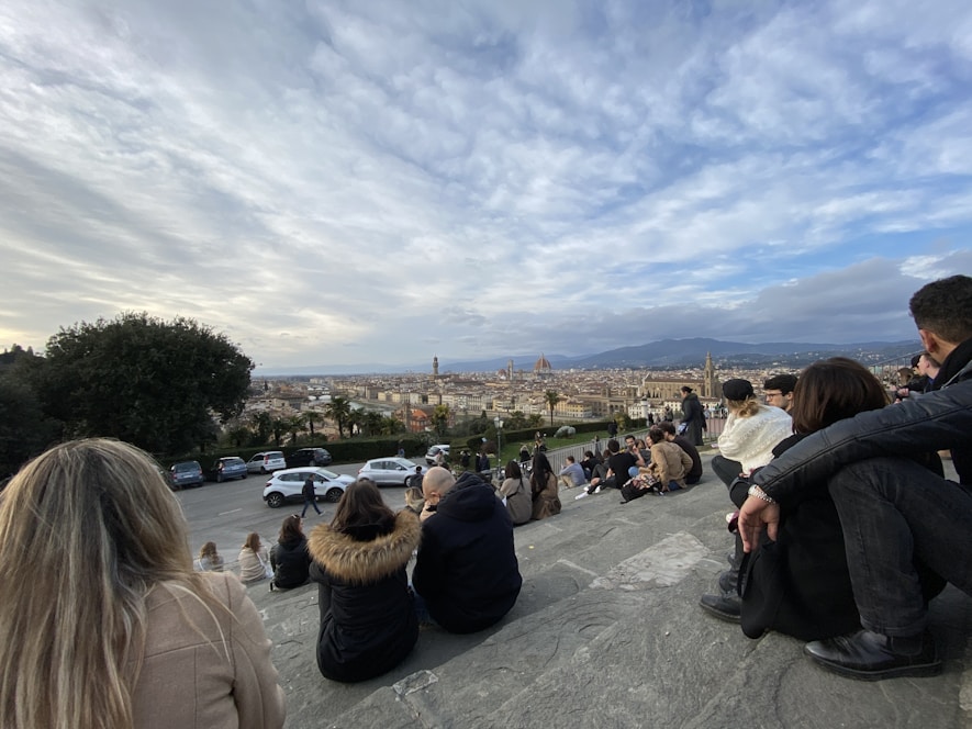 A vibrant group of travelers enjoying a scenic European landmark together, smiling and sharing moments.