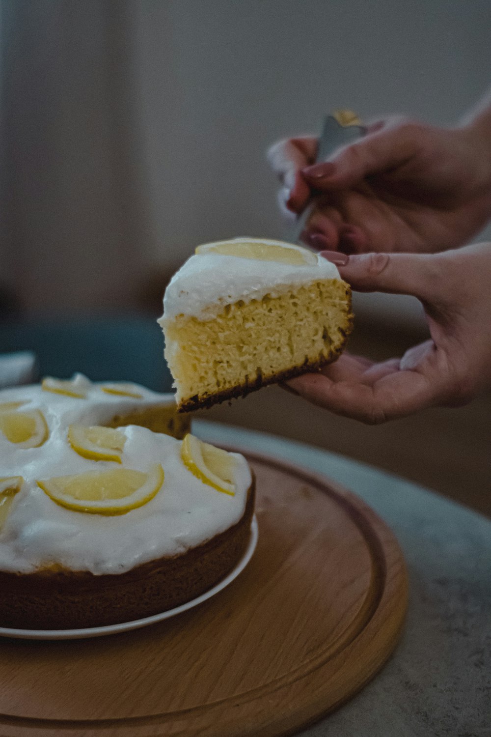 a person cutting a cake