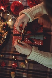 a person holding a red and gold object