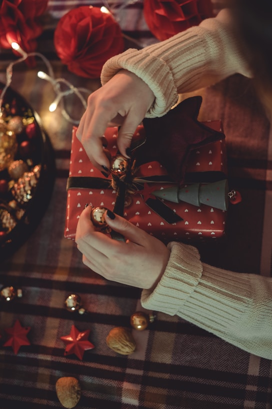 a person holding a red and gold object