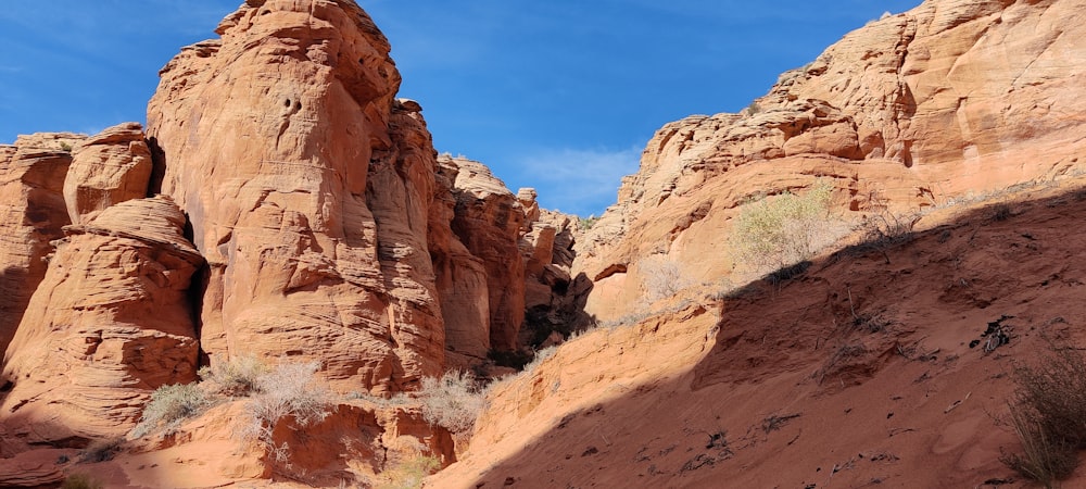 a rocky canyon with a blue sky