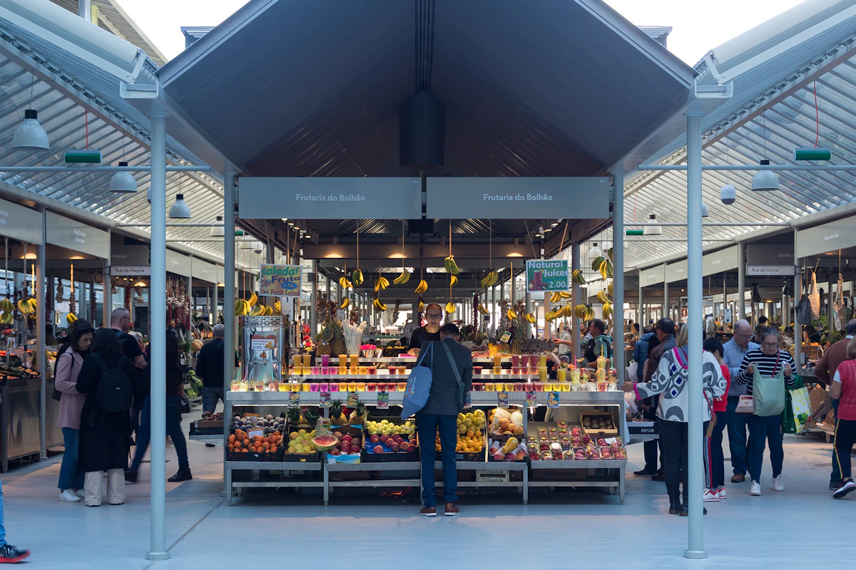Shoppers browsing colourful produce at Mercado do Bolhão in Porto