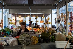 a person selling vegetables at a market