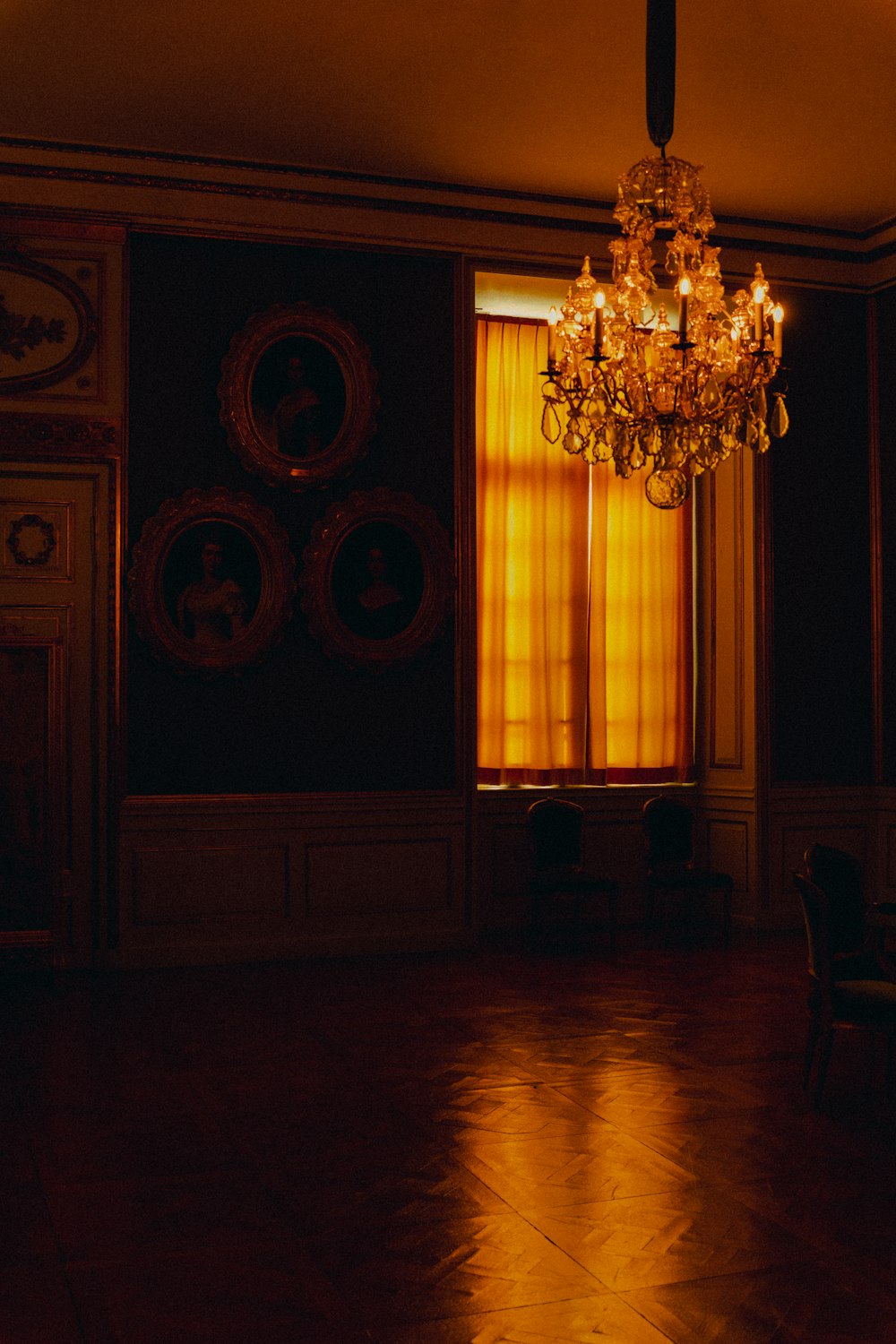 a room with a chandelier and chairs