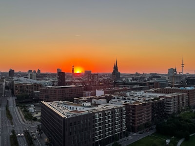Urban skyline of Manchester with tech hub landmarks at sunset.