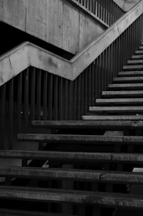 Metal railing installed along an outdoor stairway with industrial surroundings.