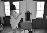 A traveler unpacking luggage inside a charming French countryside cottage
