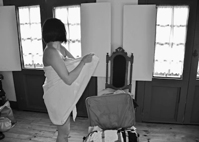 A traveler unpacking luggage inside a charming French countryside cottage