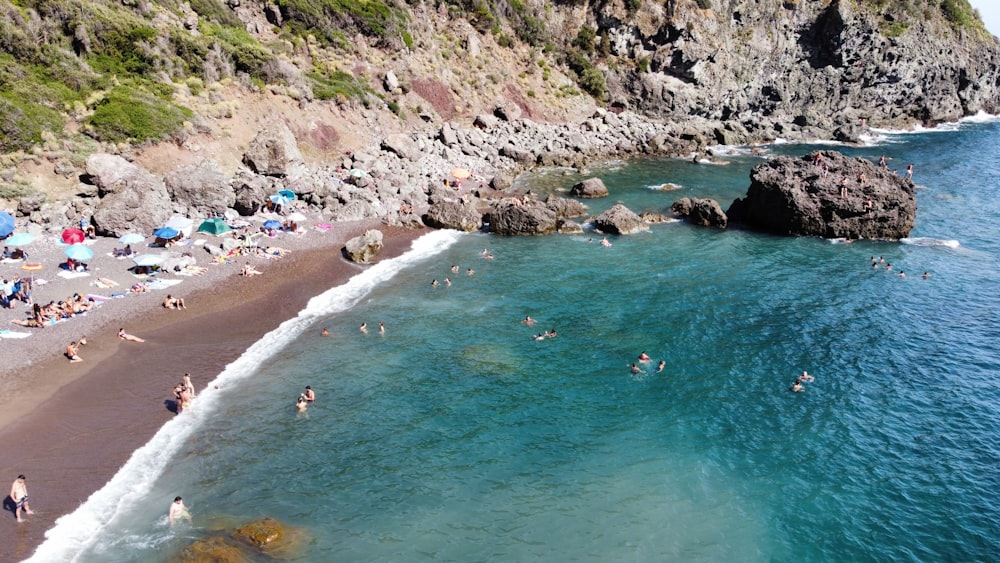 a beach with people swimming
