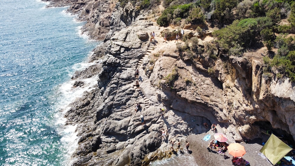 a group of people on a rocky beach