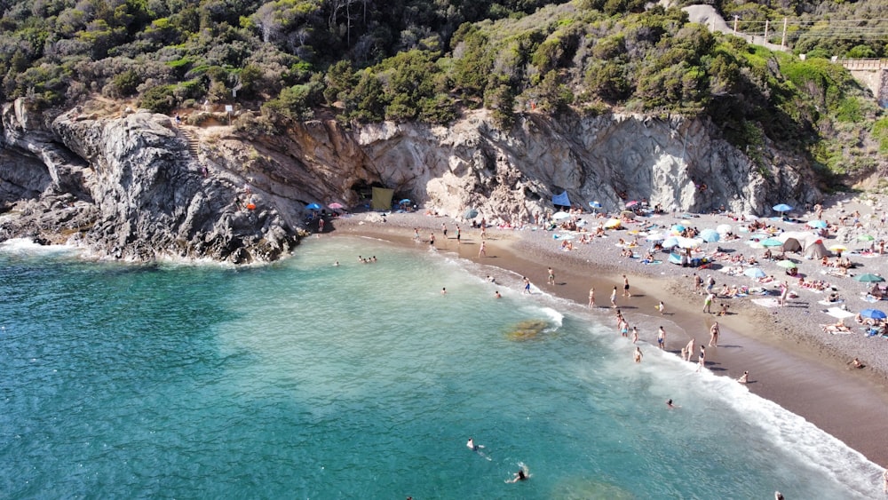 a beach with people and rocks