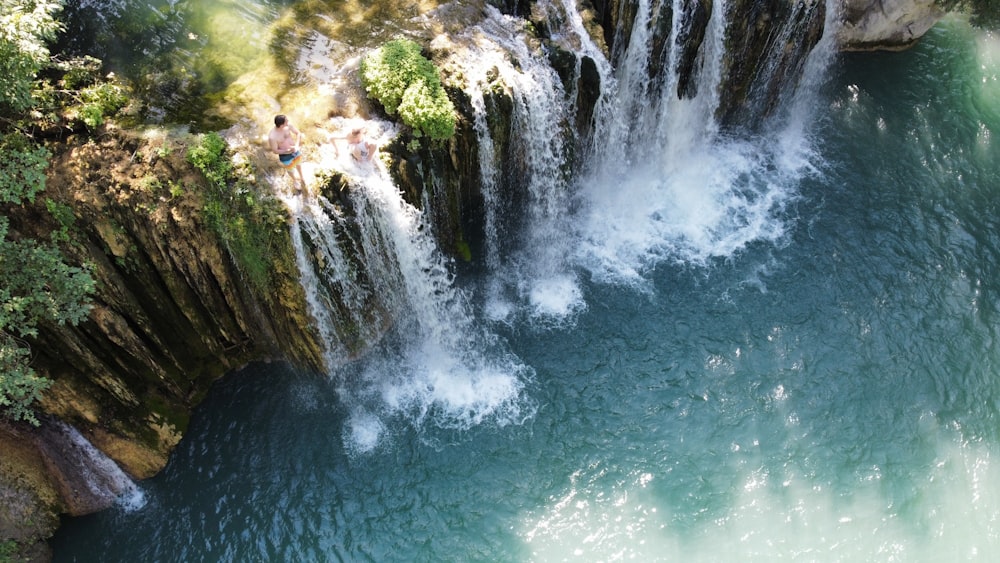 a waterfall with people on it