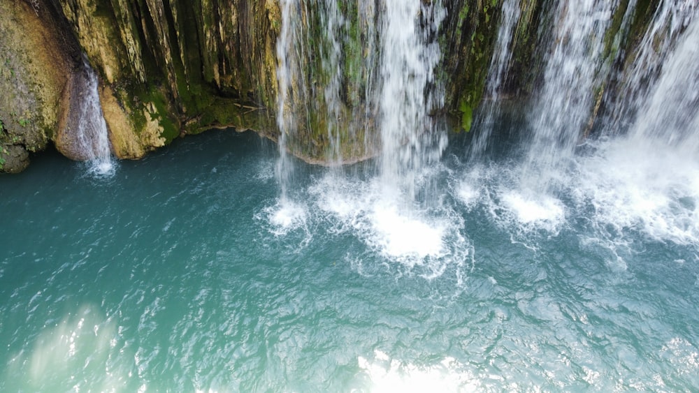 a waterfall with a rainbow