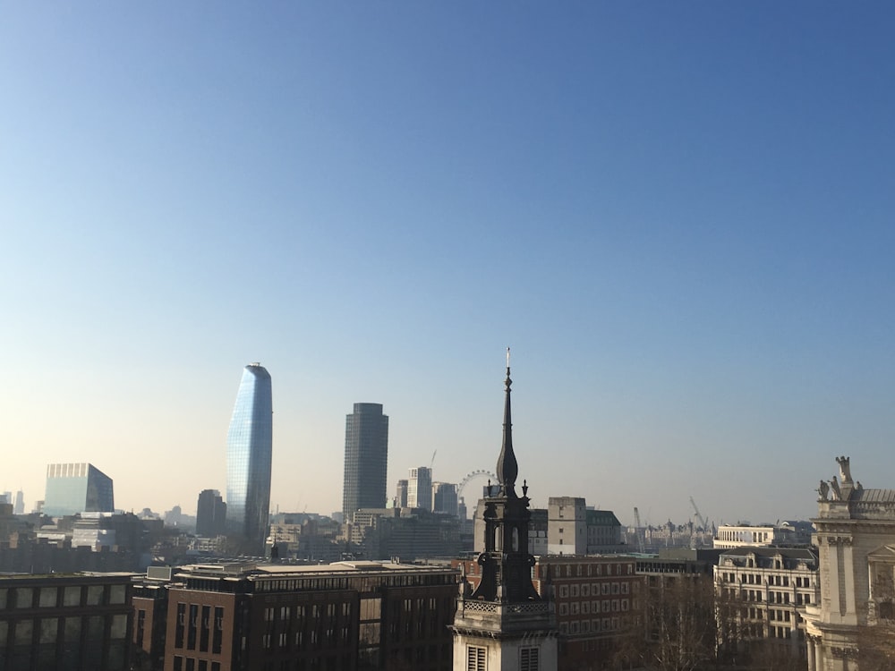 a city skyline with a tall tower