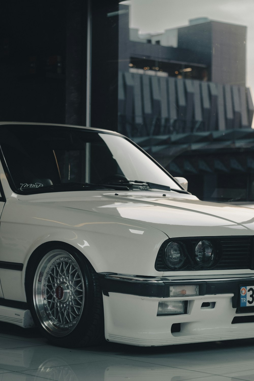 a white car parked in front of a building