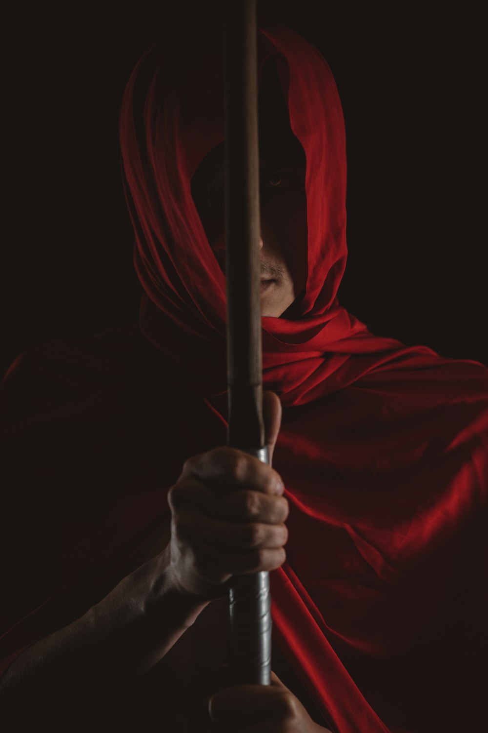 a person holding a red and white flag