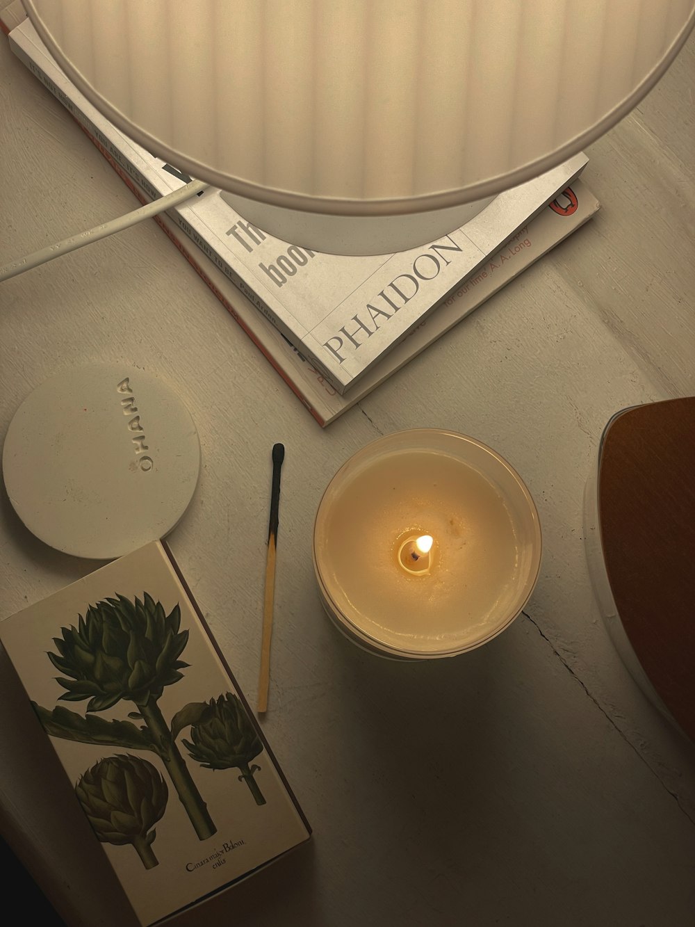 a candle and a plate on a table