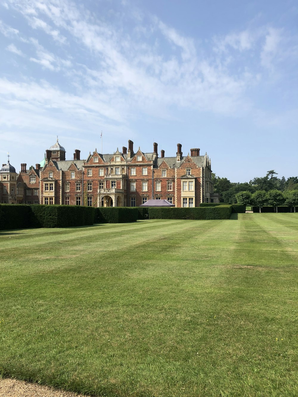 a large building with a lawn in front of it