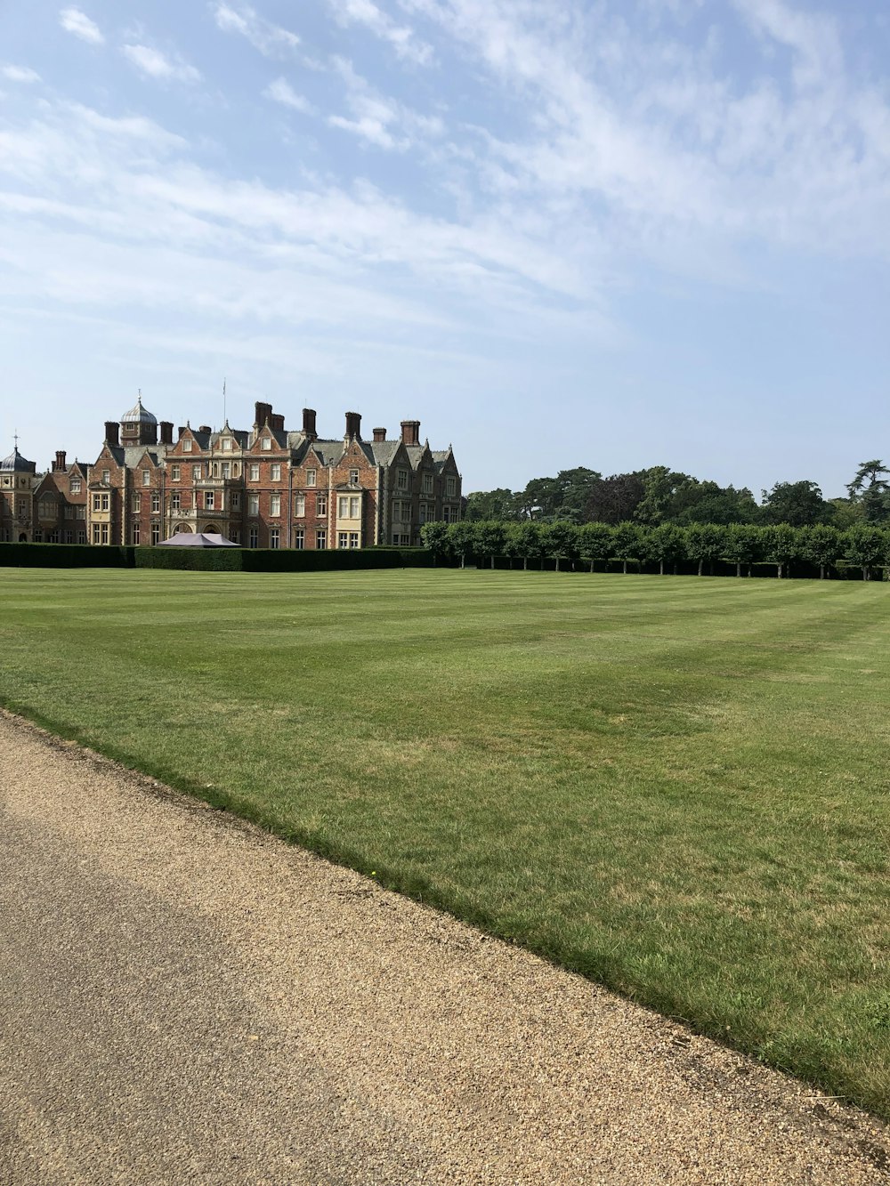 a large building with a lawn in front of it