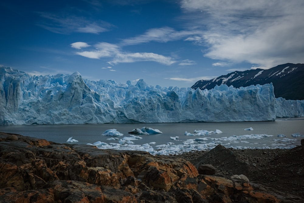 a body of water with ice and snow on the side with Perito Moreno Glacier in the background