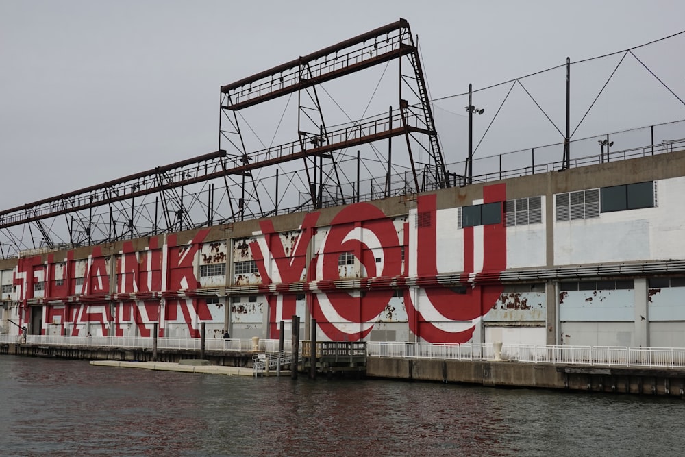 a large red and white bridge over water