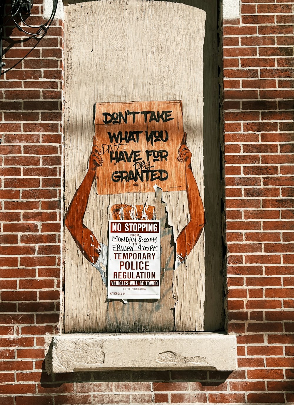 a sign on a brick wall