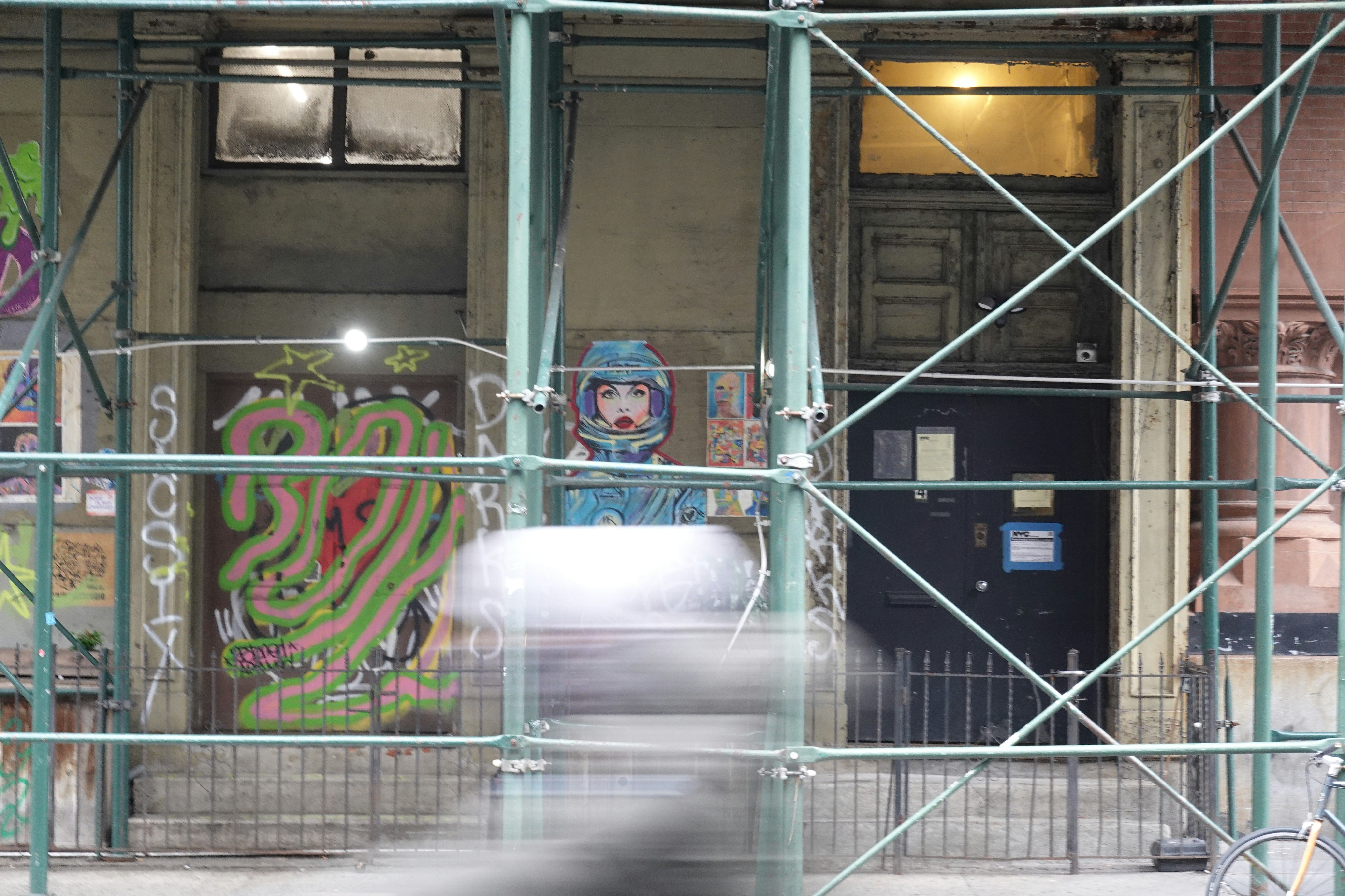 a building with a gate and a statue in front of it