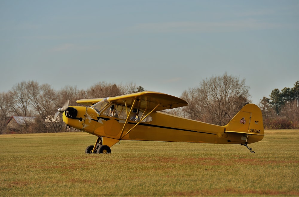 a yellow plane on a field