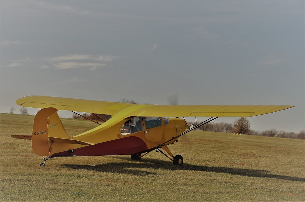 a yellow plane on a field