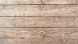 An arrangement of wooden planks featuring a natural texture with visible knots and grain patterns running horizontally.