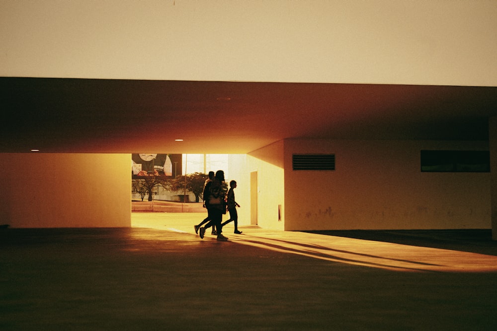 a couple of people walking in a hallway