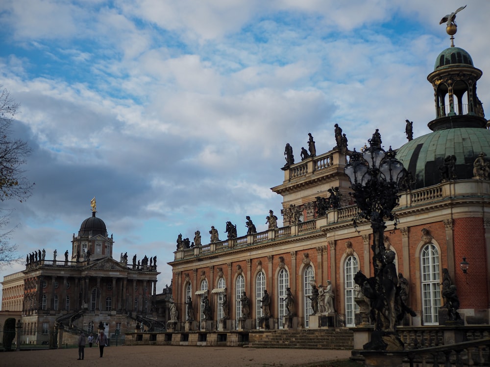 a large building with statues in front of it with Kelvingrove Art Gallery and Museum in the background