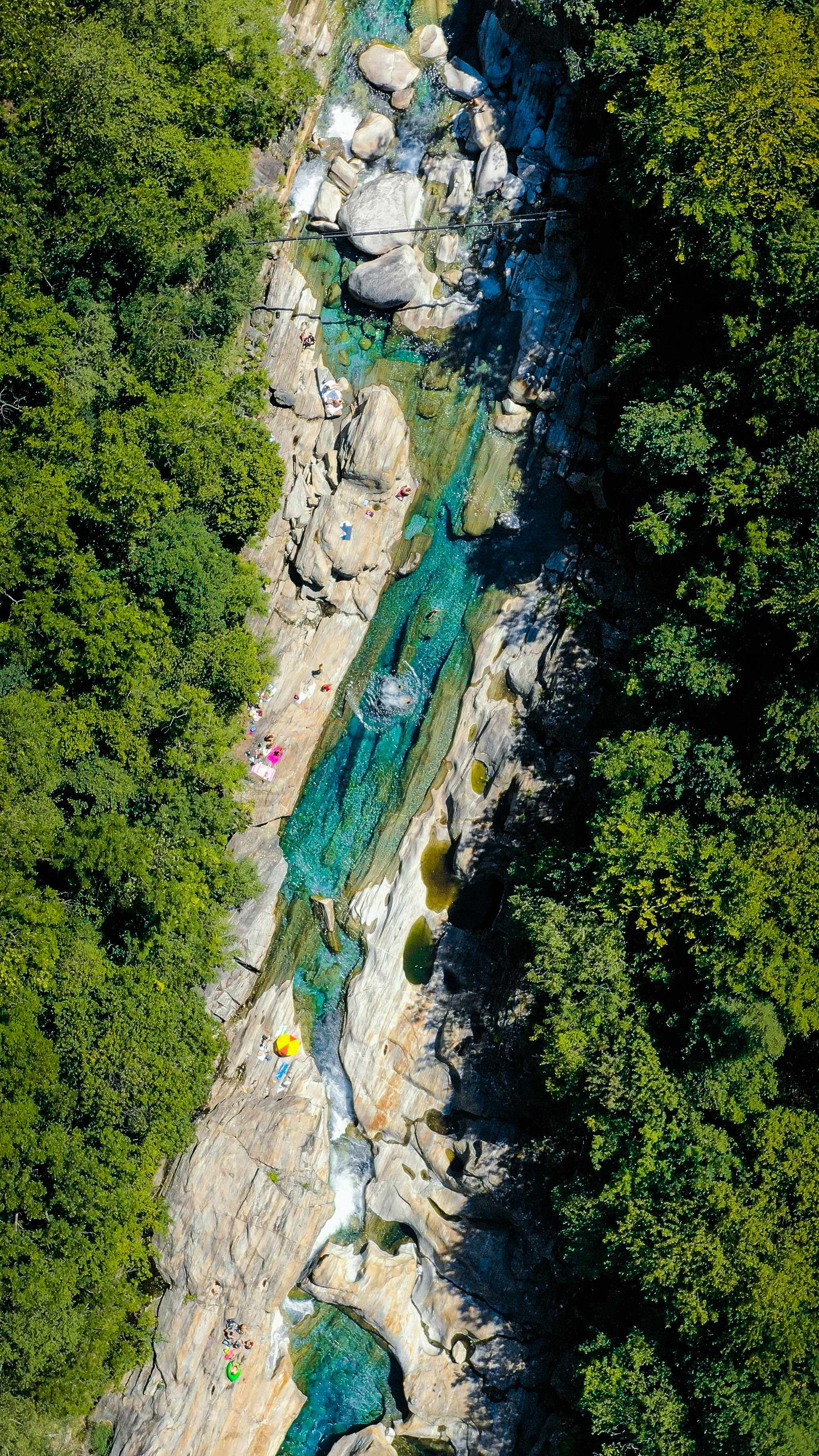 a river with a waterfall and trees