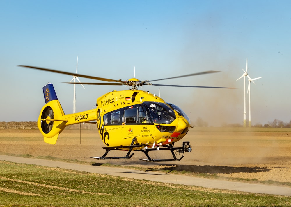 a yellow helicopter on a field