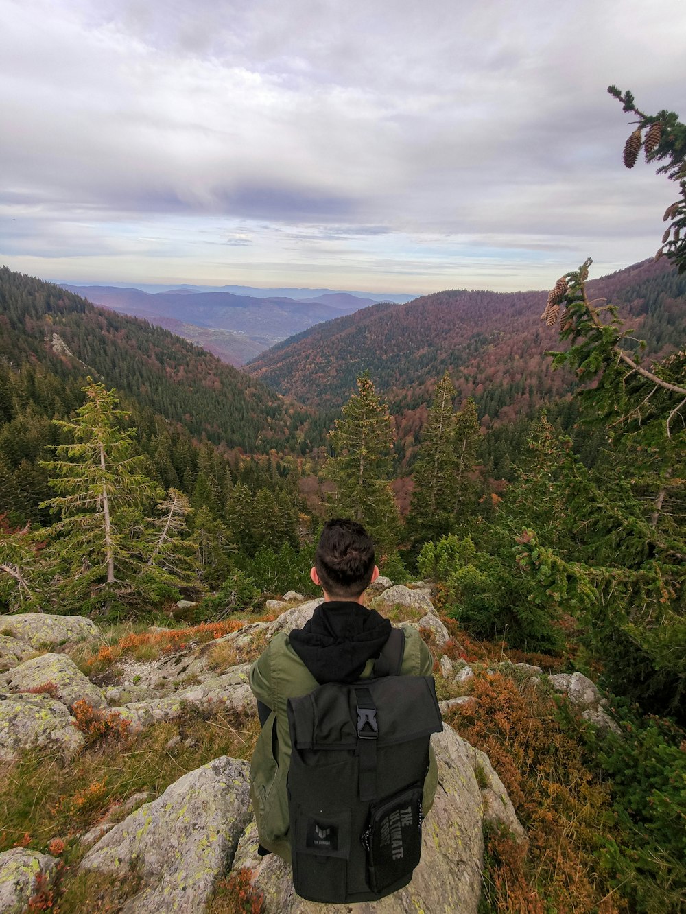 a person with a backpack on a mountain top