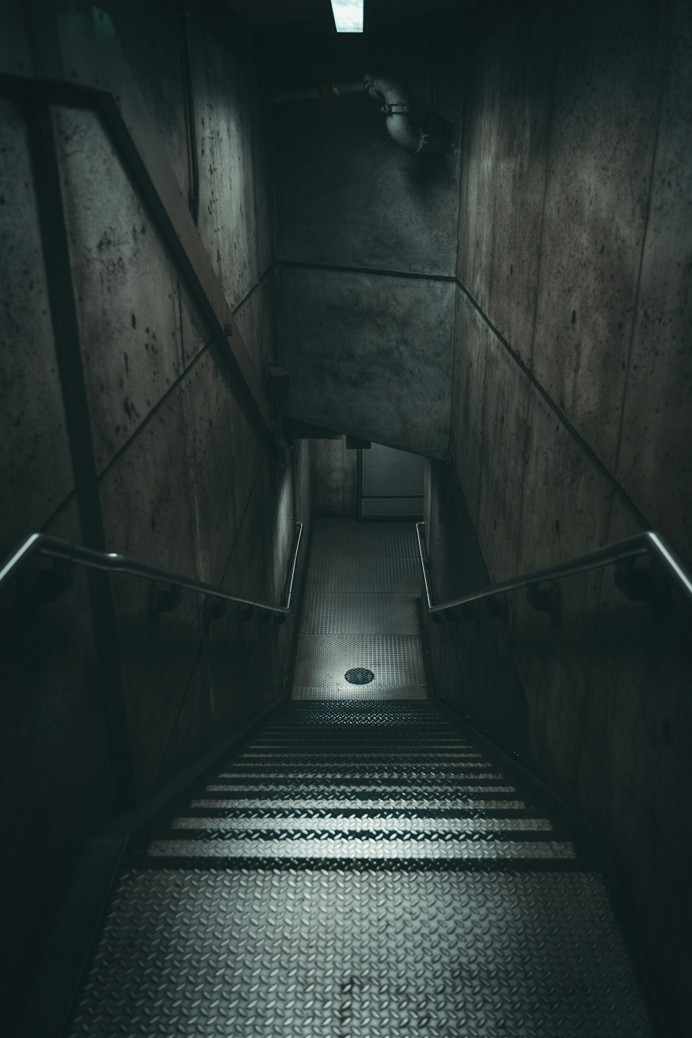 a dark staircase with a light at the end