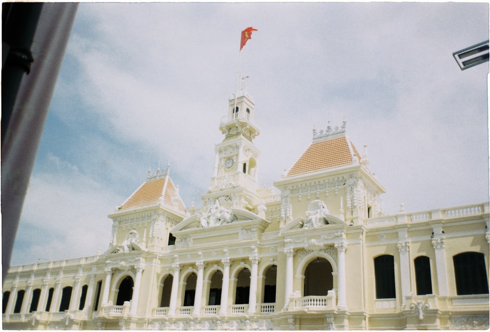 a large white building with a flag on top