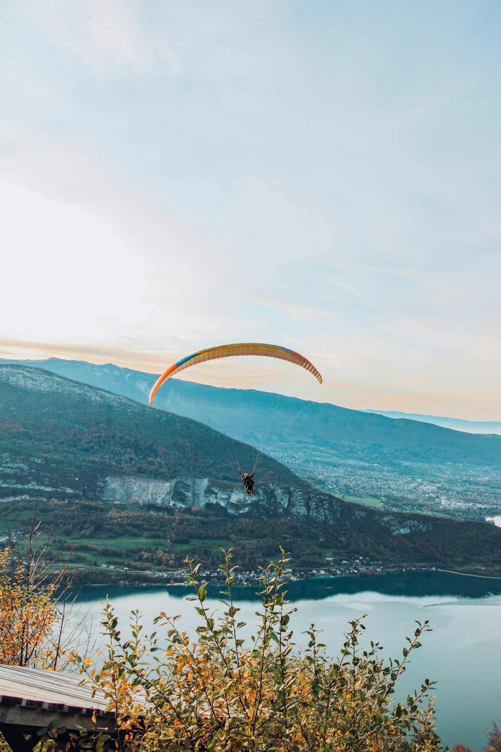 a person parachuting over a lake