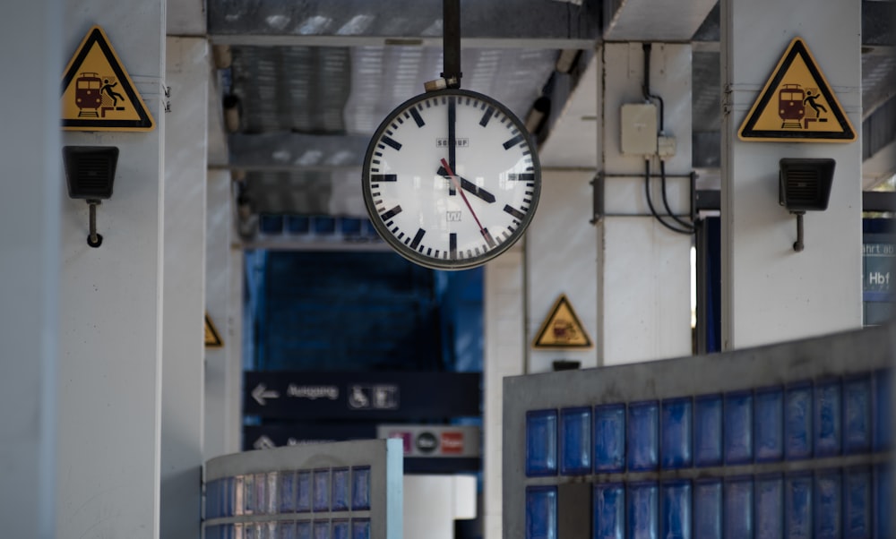 a clock hangs from the ceiling