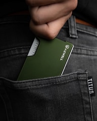 a hand holding a green rectangular object