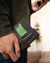 Close-up of hands holding a health insurance card.