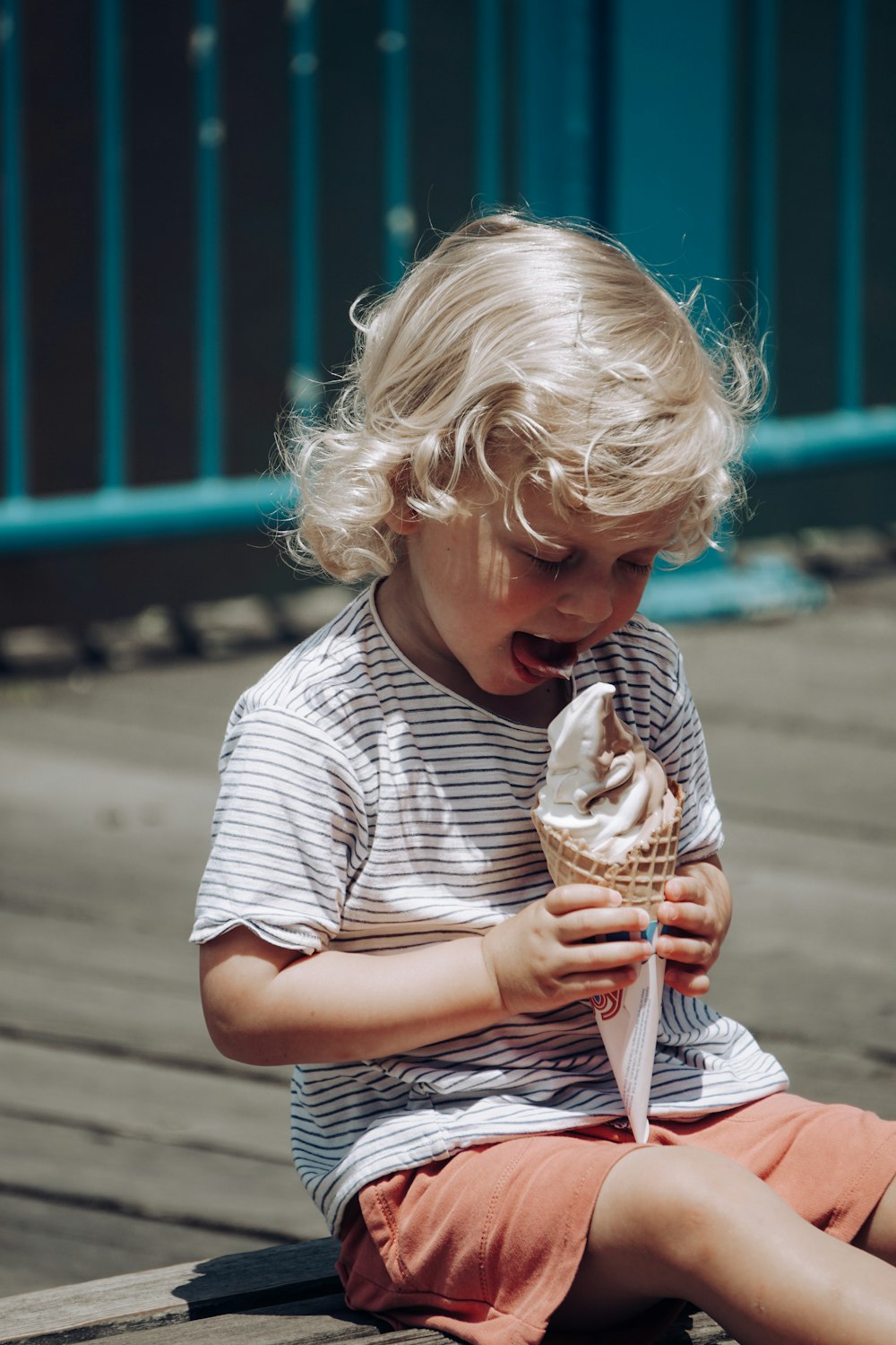 a child holding an ice cream cone