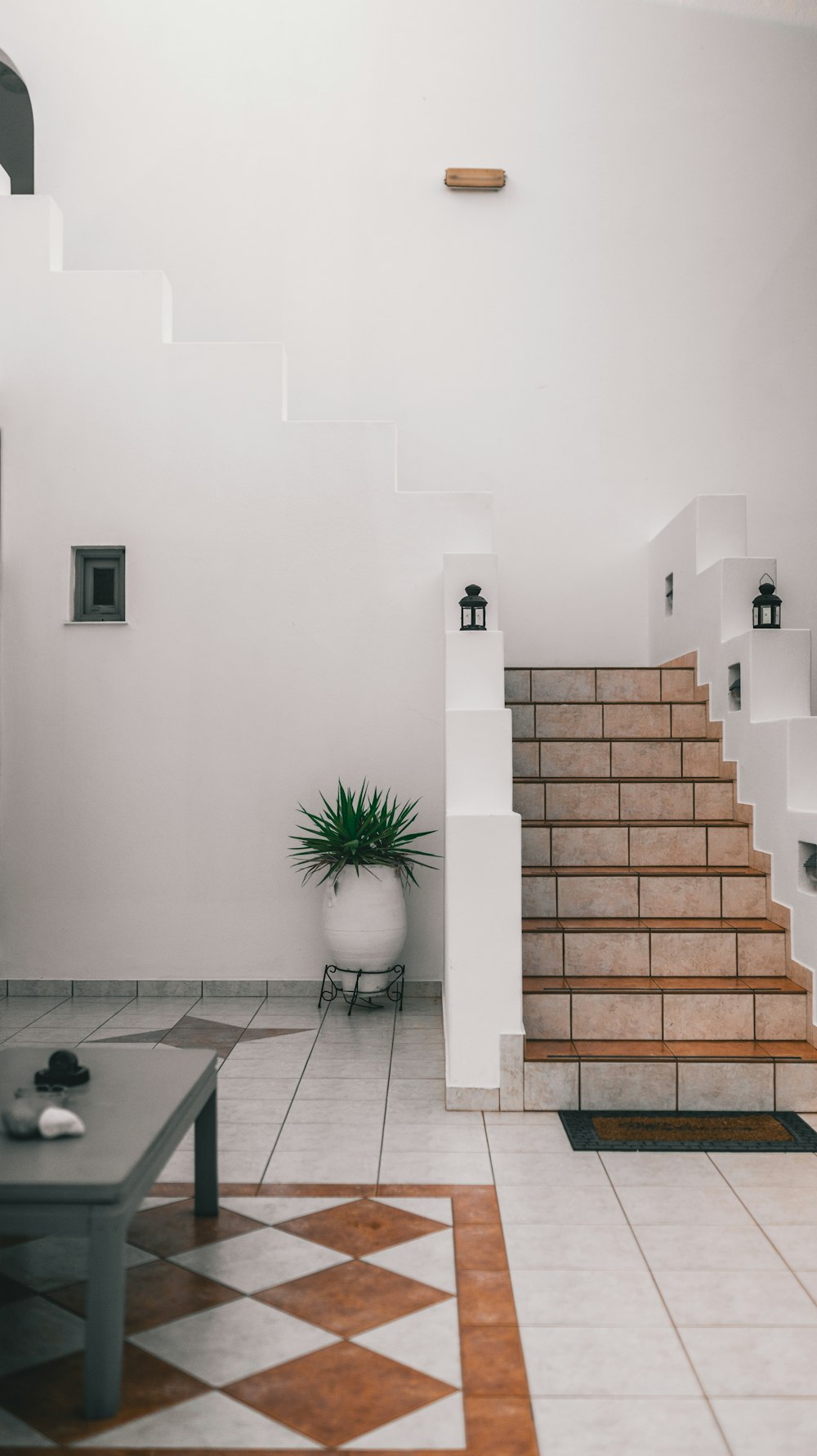 a room with a table and a staircase