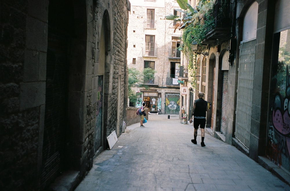 people walking down a narrow street