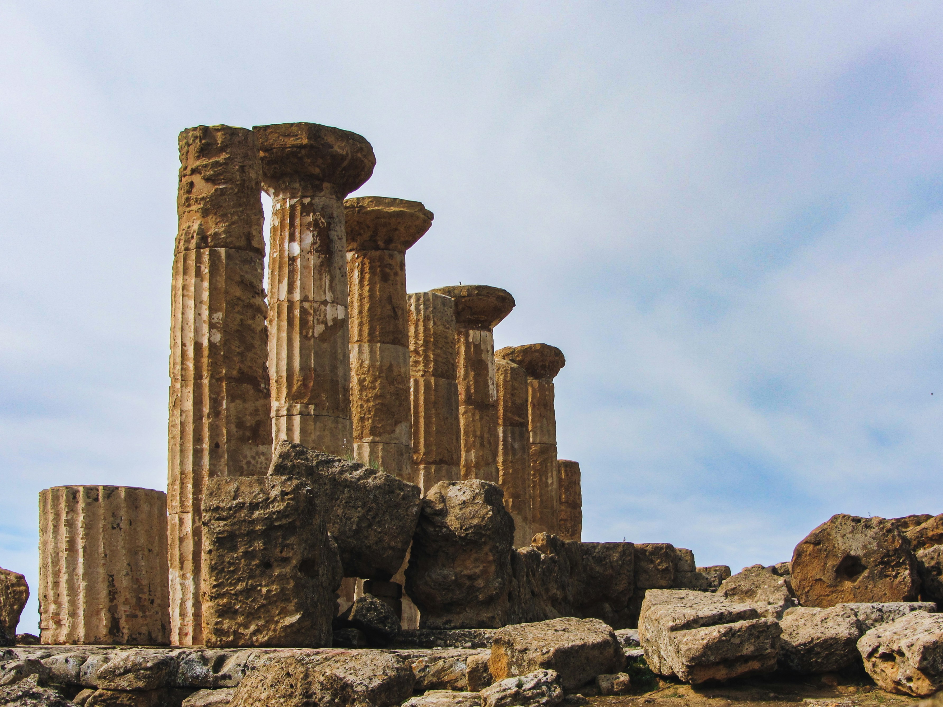 a stone structure with a few columns, Temple of Heracles in Agrigento, Sicily