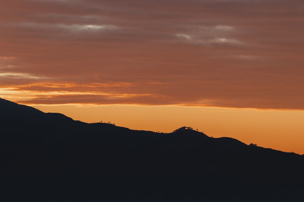 a mountain with a sunset in the background